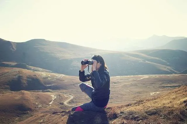 Woman using binoculars in Adventure