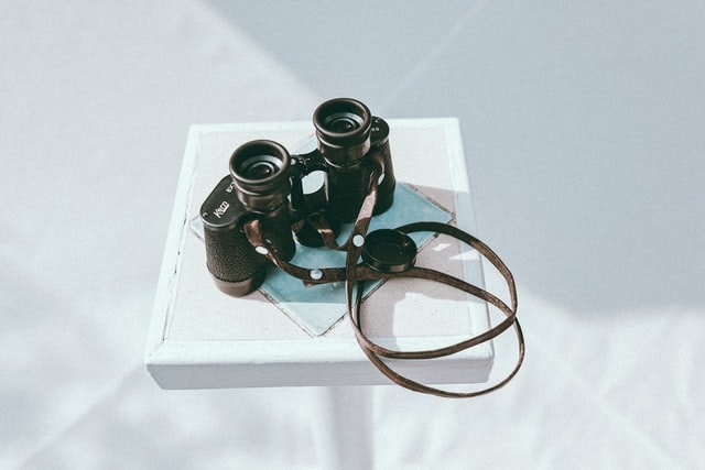 black binoculars on white table
