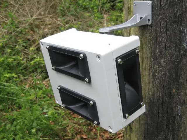 White and black box attached to a tree