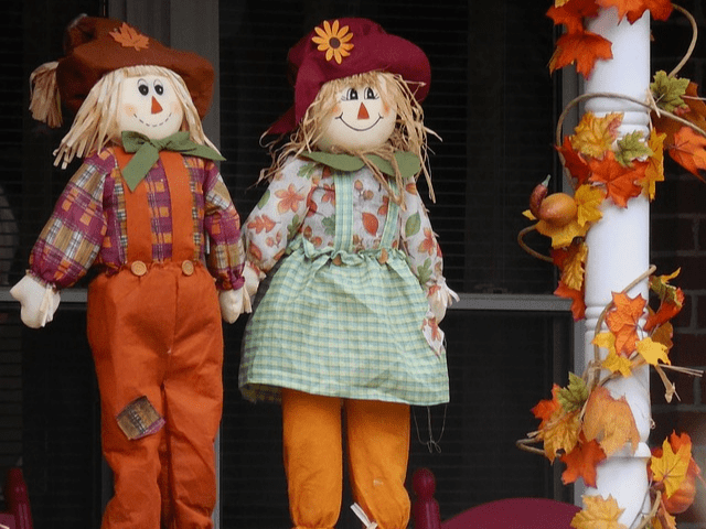boy and girl scarecrow dressed for autumn