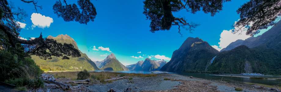 A beautiful mountain scene with water in the forefront.