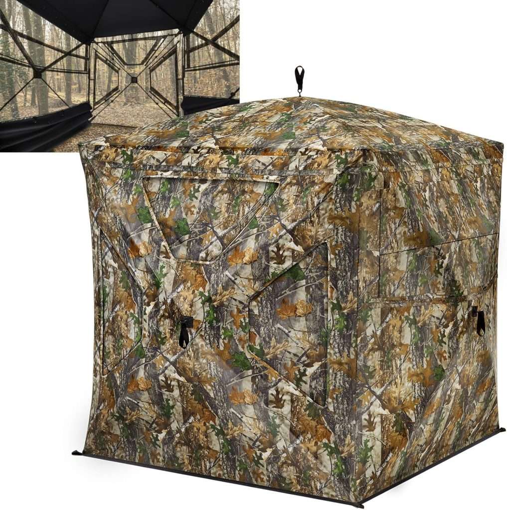 A camouflaged colored square tent with a lens sized hole in it.
