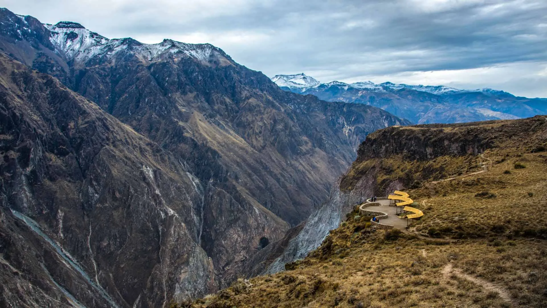 A shot of high mountains dropping to a river.