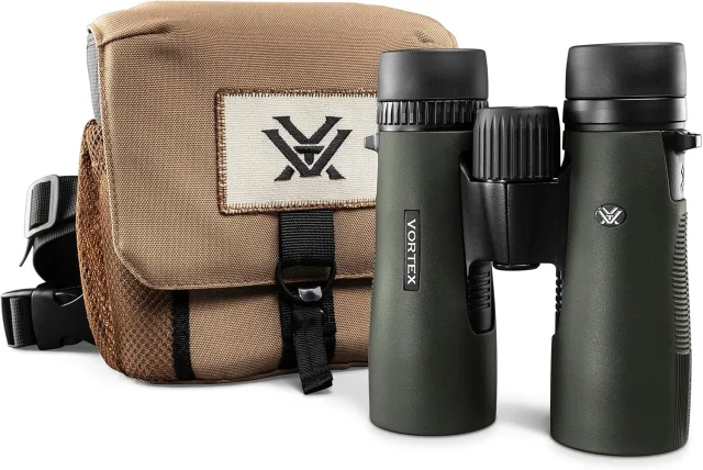 A pair of binoculars with a brown canvas carry bag.