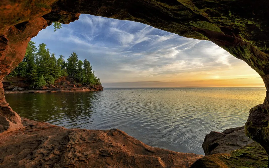 The ocean stretches away from a rocky outcrop.