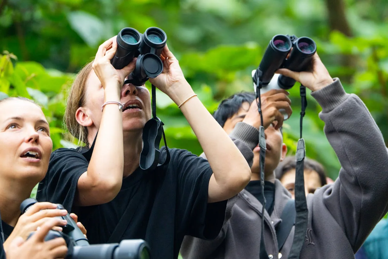 Several women are looking through binoculars .